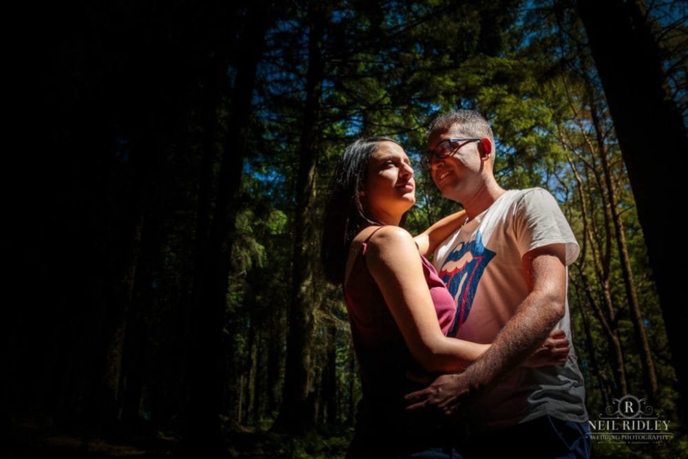 Engagement Shoot Couple embrace in the forest at Beacon Fell Lancashire