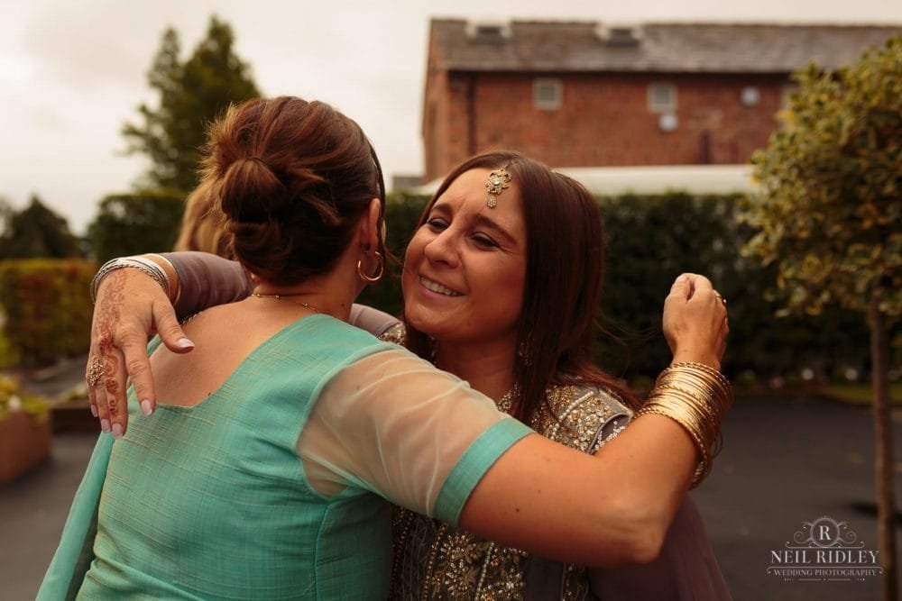 Merrydale Manor Wedding Photographer - Wedding guests embrace